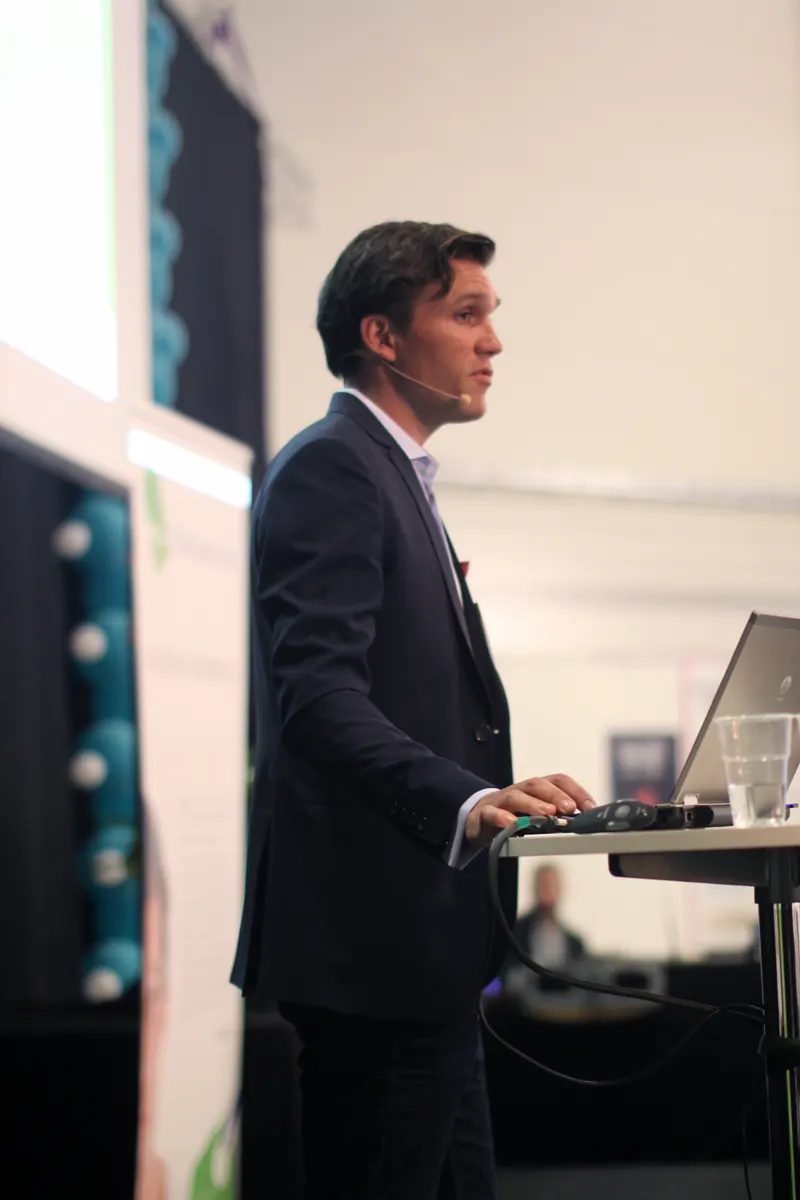 Karl Lillrud delivering a keynote at a lectern